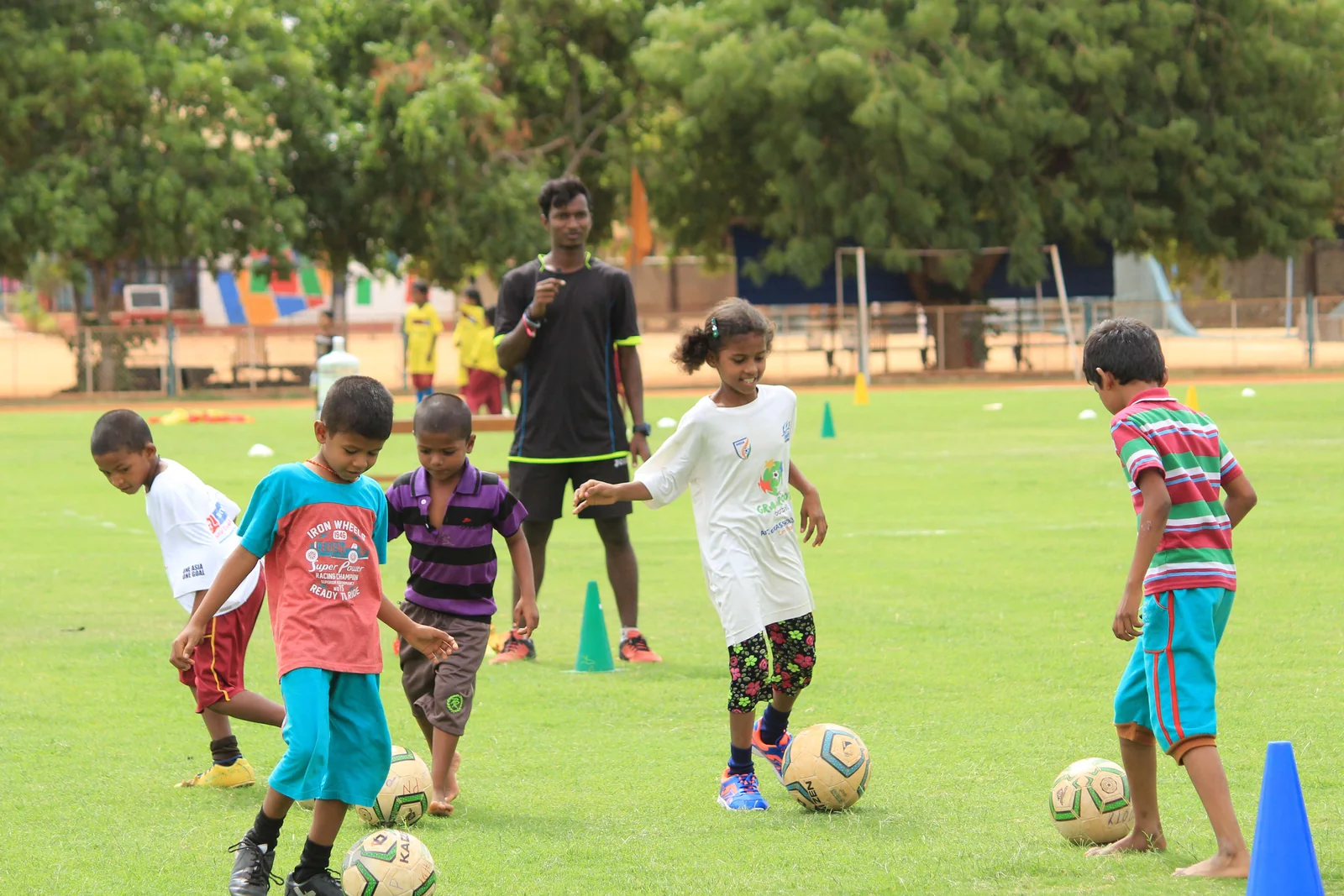 ASA football coach guiding young children during a session
