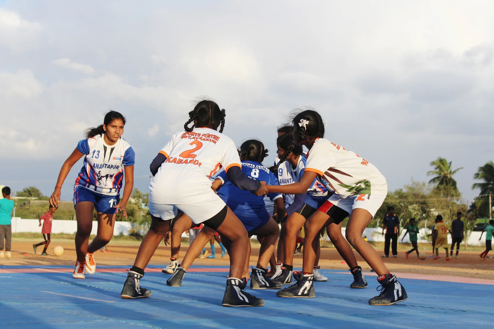 ASA girls playing hockey together outdoors