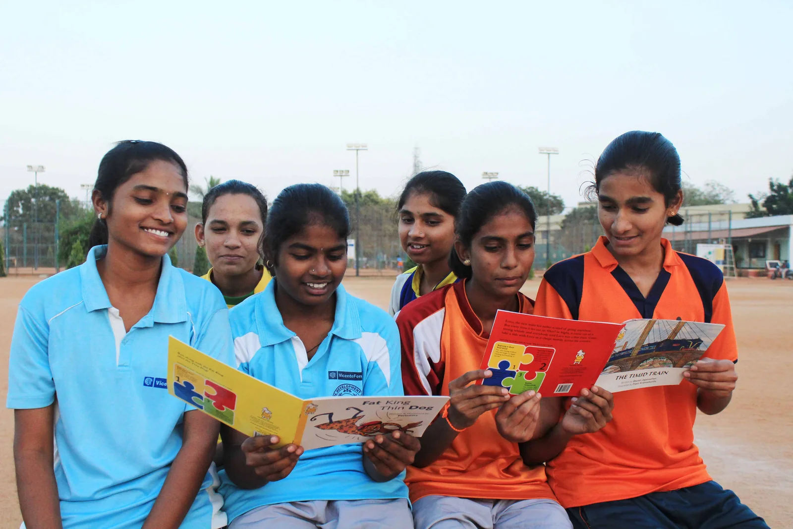 ASA girls reading together as part of a learning activity